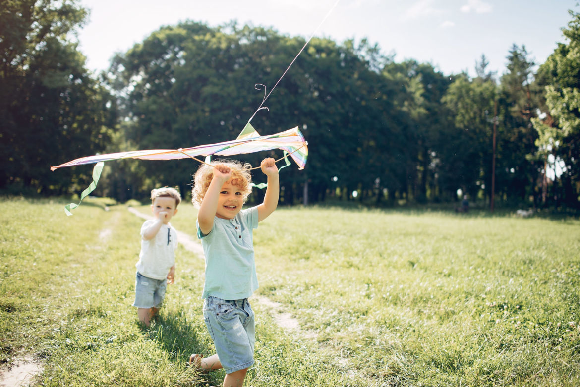 cute-little-child-summer-field-with-kite-scaled.jpg